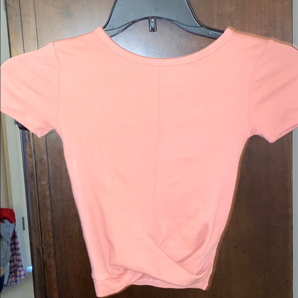 Pink crop tip with a tied knot at the bottom.